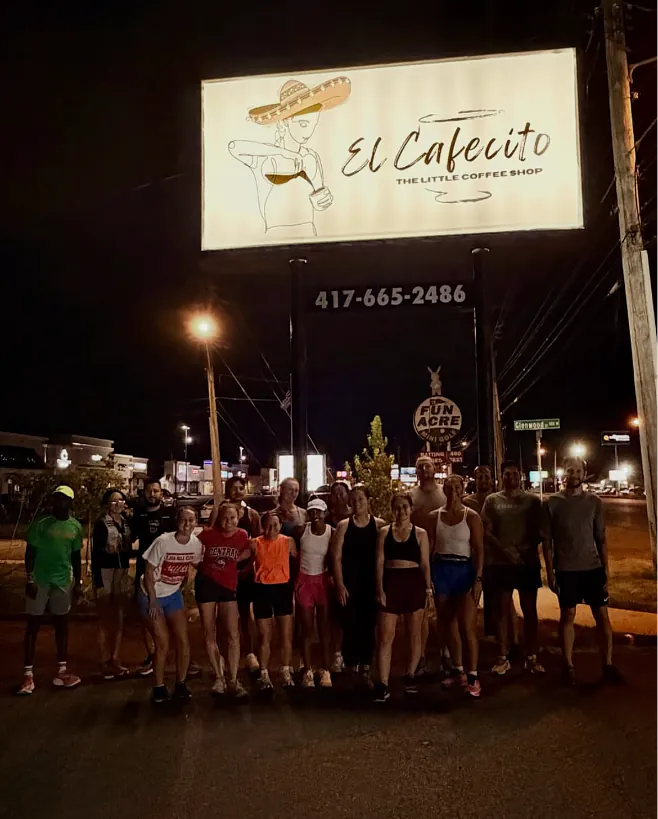 Run club group photo at night in front of El Cafecito